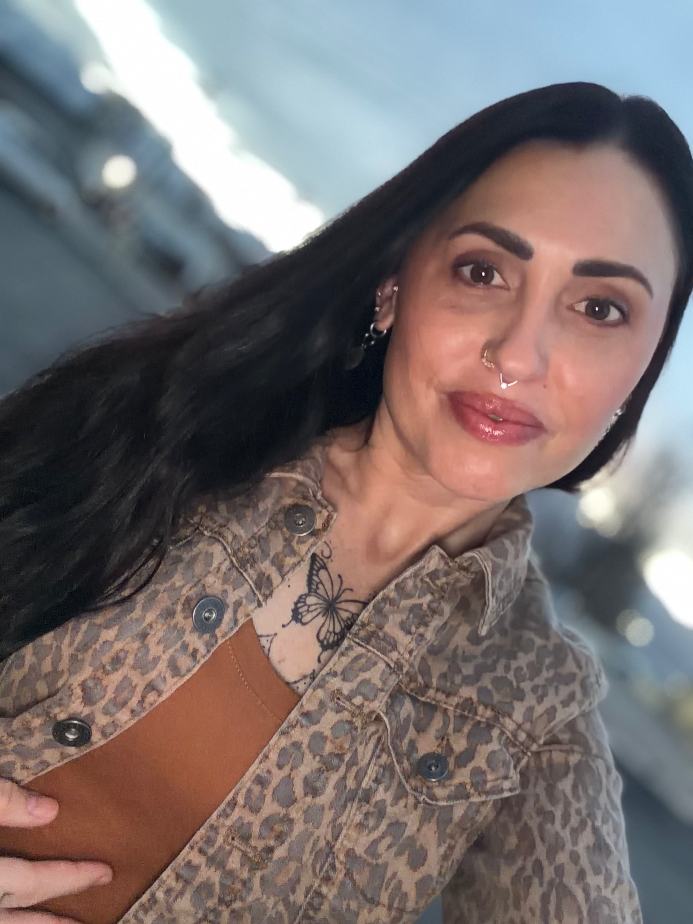 Woman wearing a leopard print jacket with a blurred background