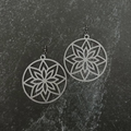 Star-shaped earrings on a dark stone surface