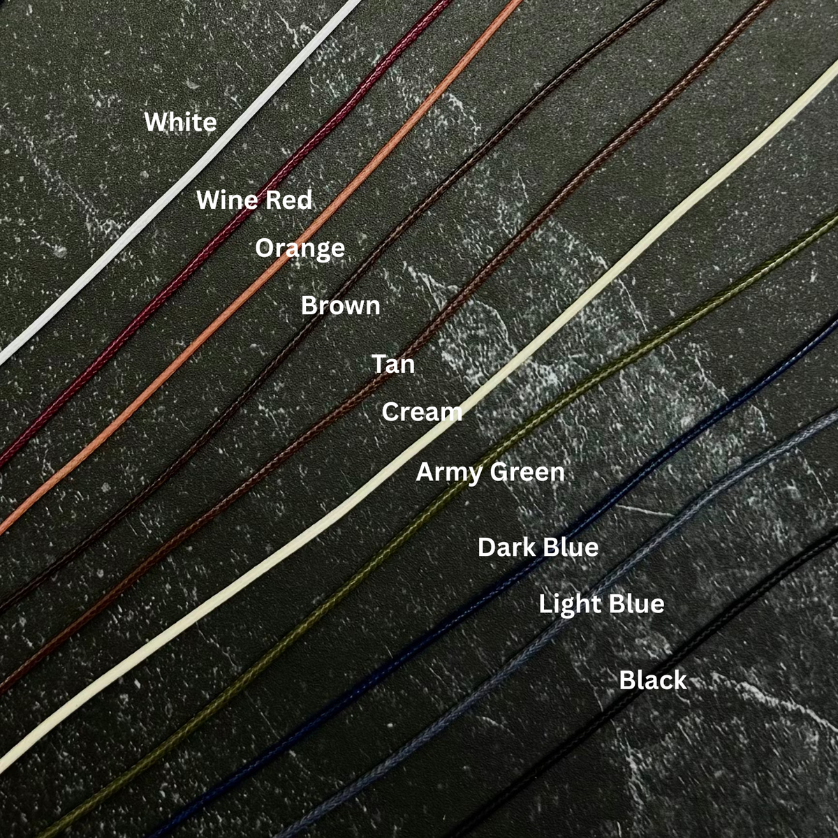 Labeled wax leather cords on slate. 