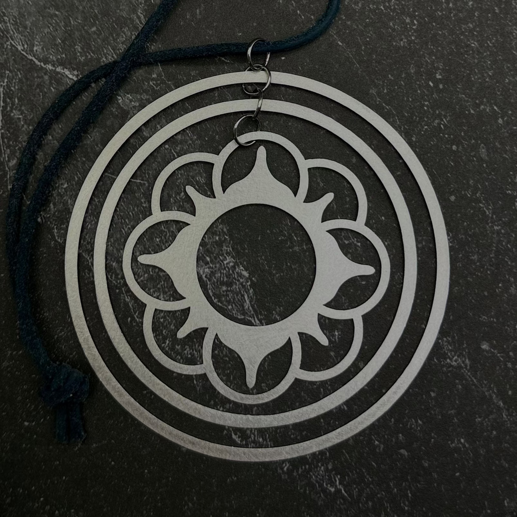 Flower stacked circle ornament design on a dark stone surface