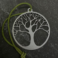 Tree of life ornament and green cord on a black background