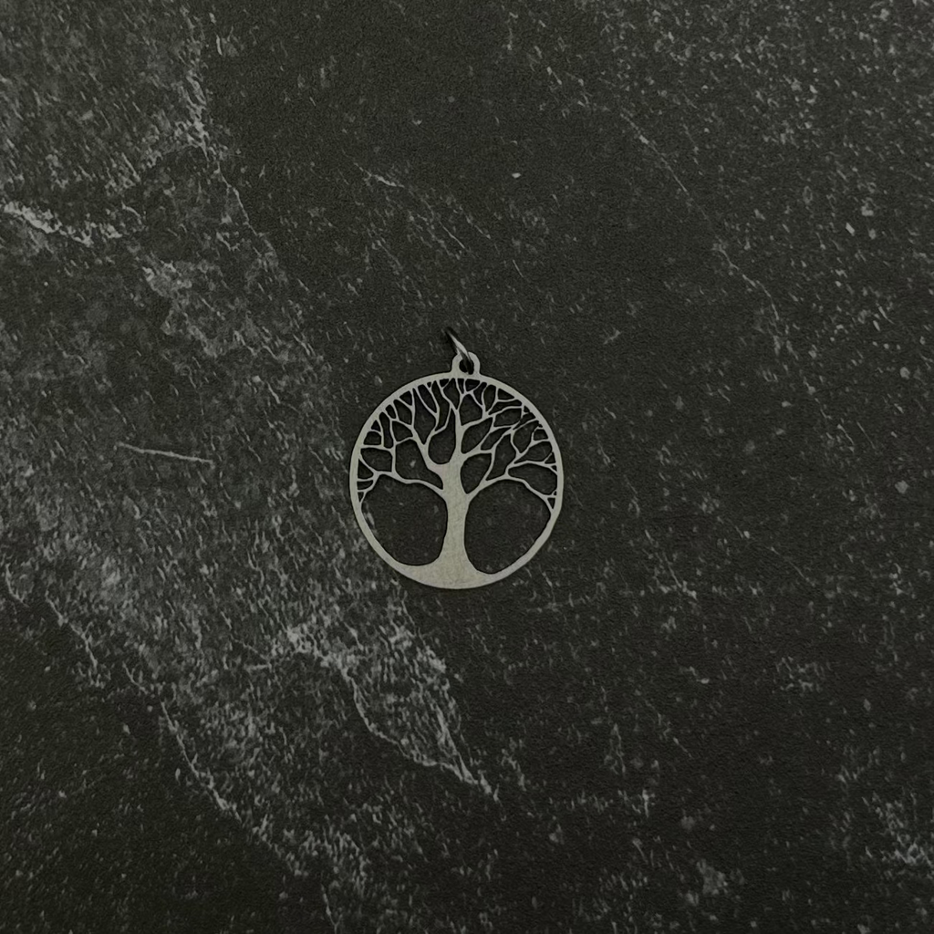 Tree of life pendant on black stone.