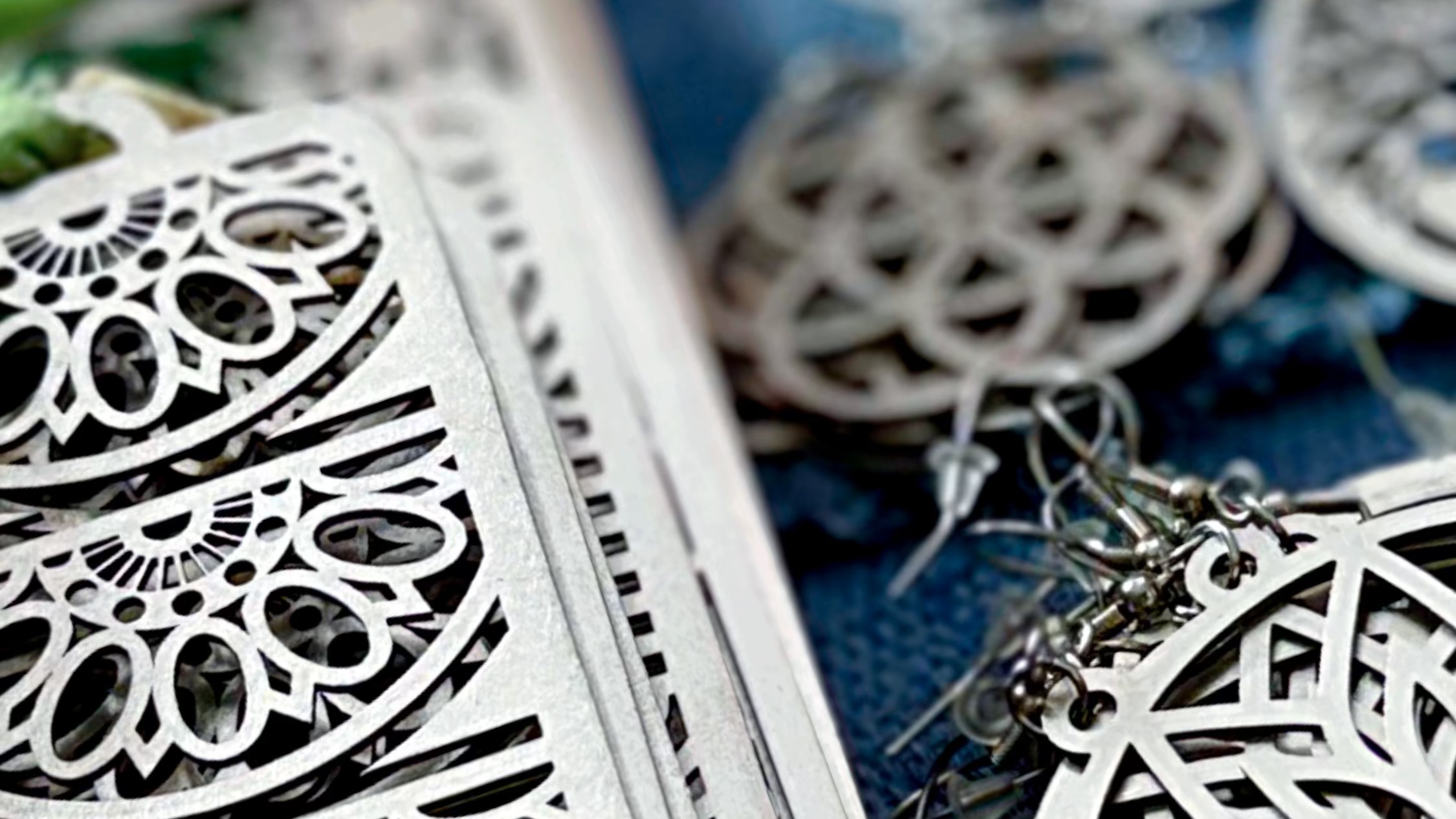 Decorative metal box with intricate patterns on a blue fabric background