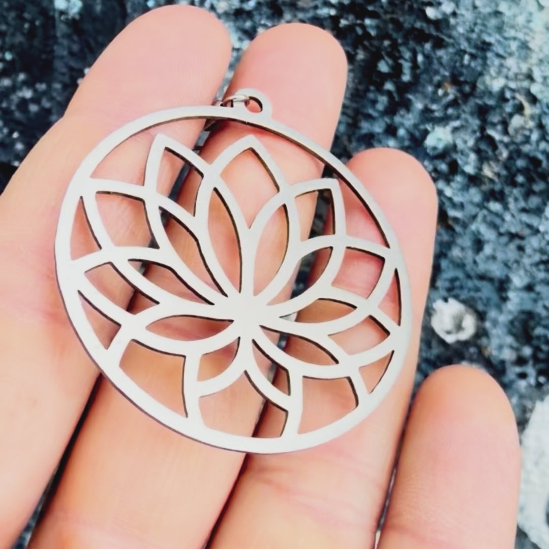 Stainless steel lotus earring with textured background. 